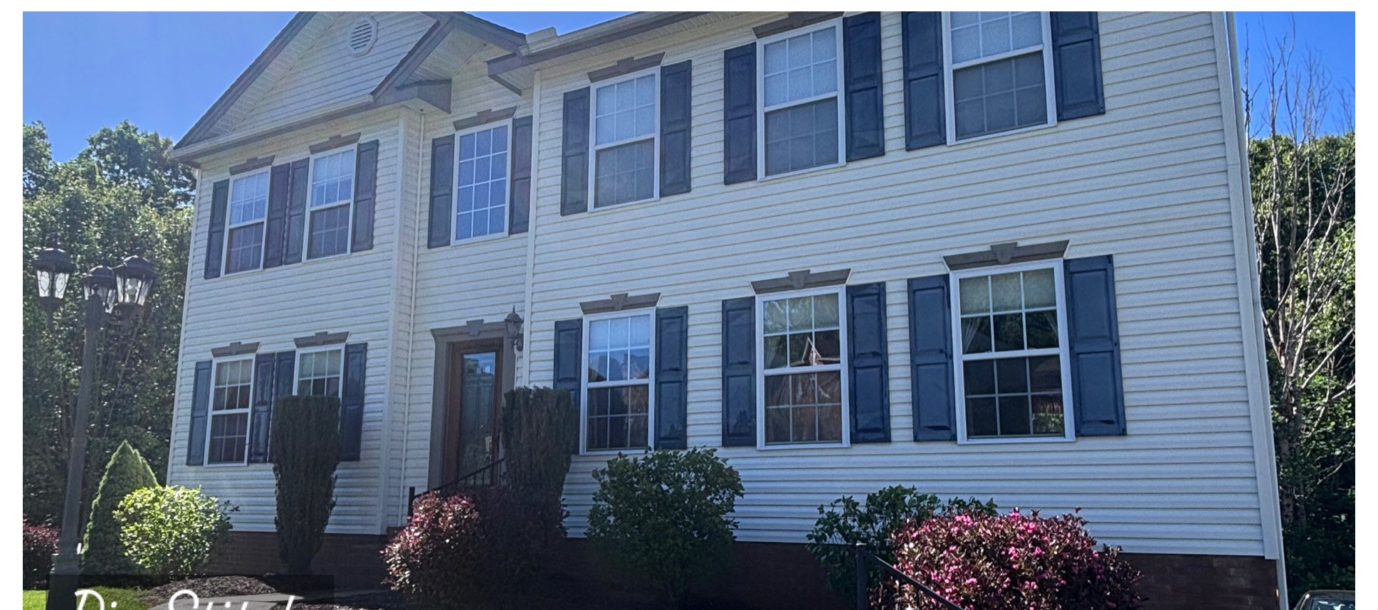 Vinyl-sided two-story house wash after