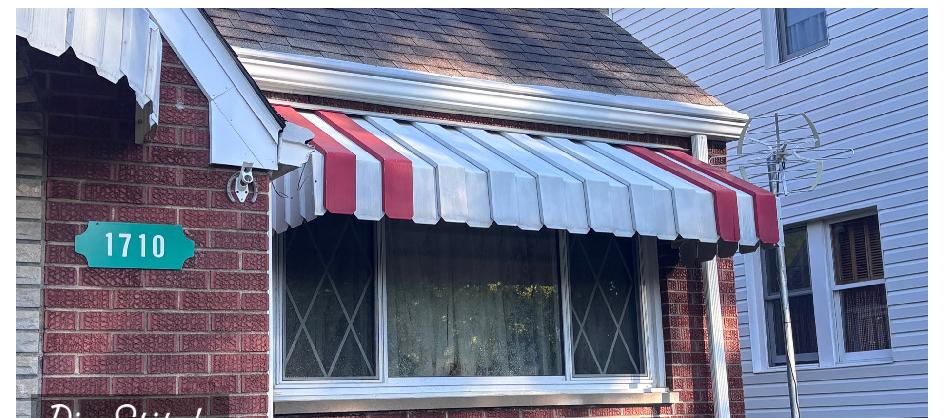 Striped window awning cleaning after