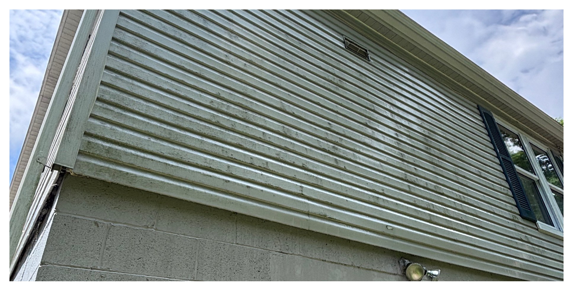 Algae-streaked siding restored before