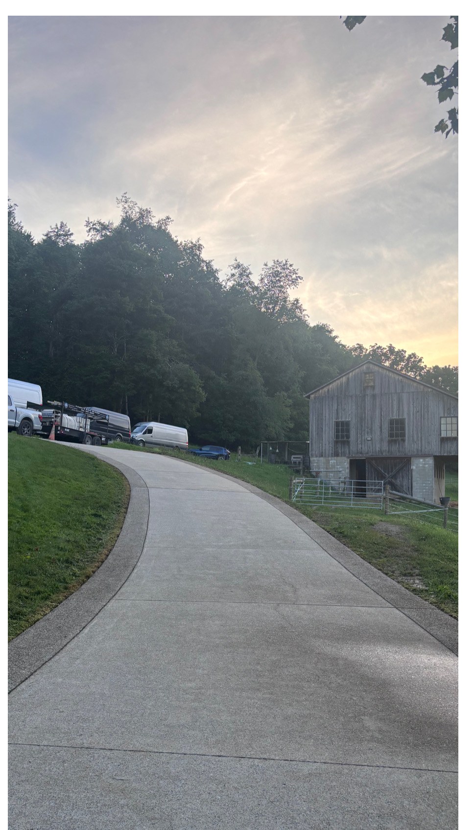 Long concrete driveway to barn after
