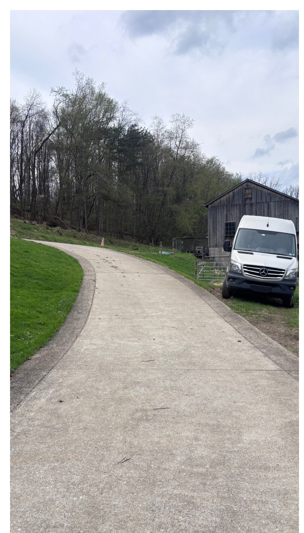 Long concrete driveway to barn before