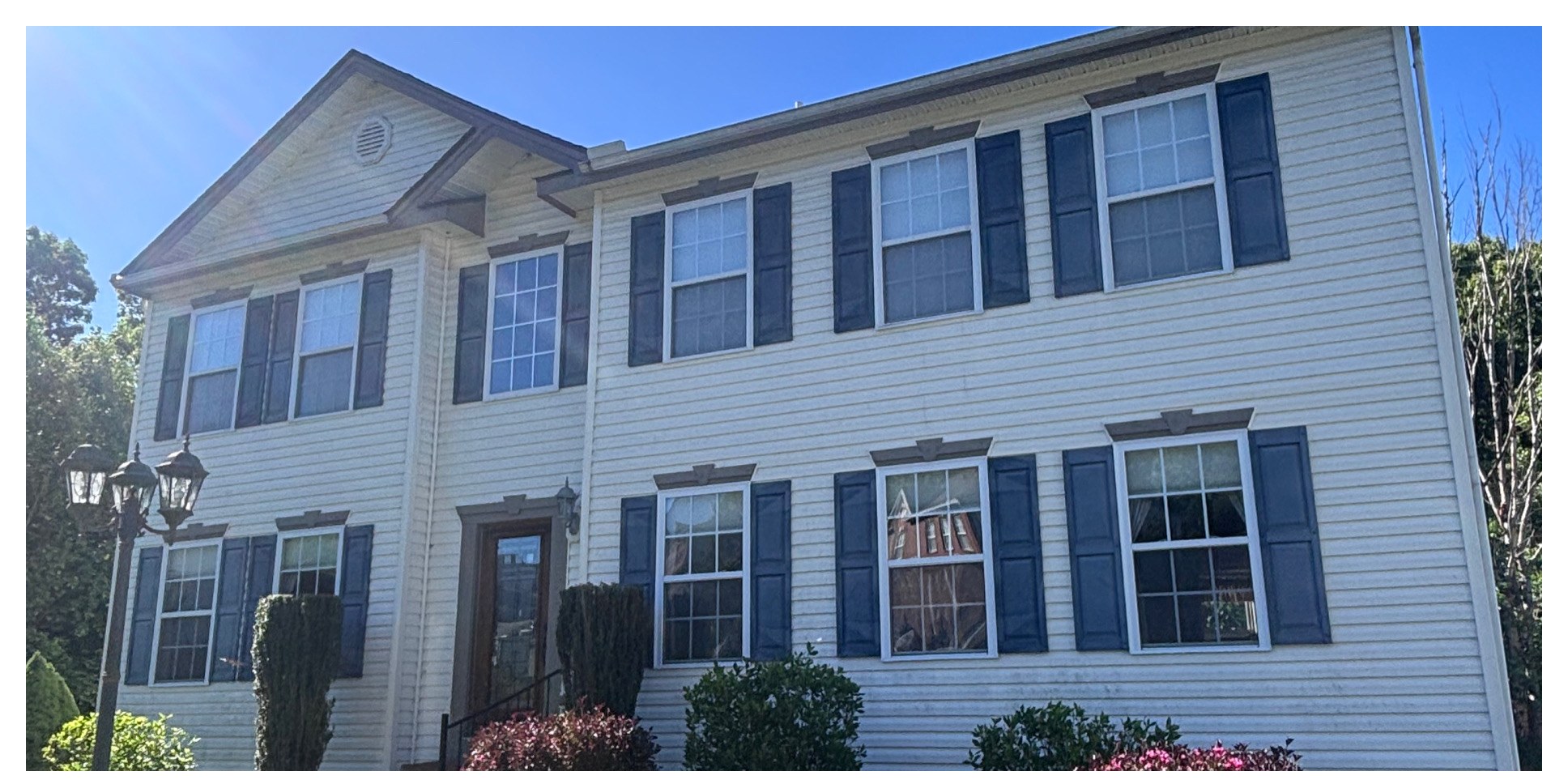 Vinyl-sided two-story house wash before