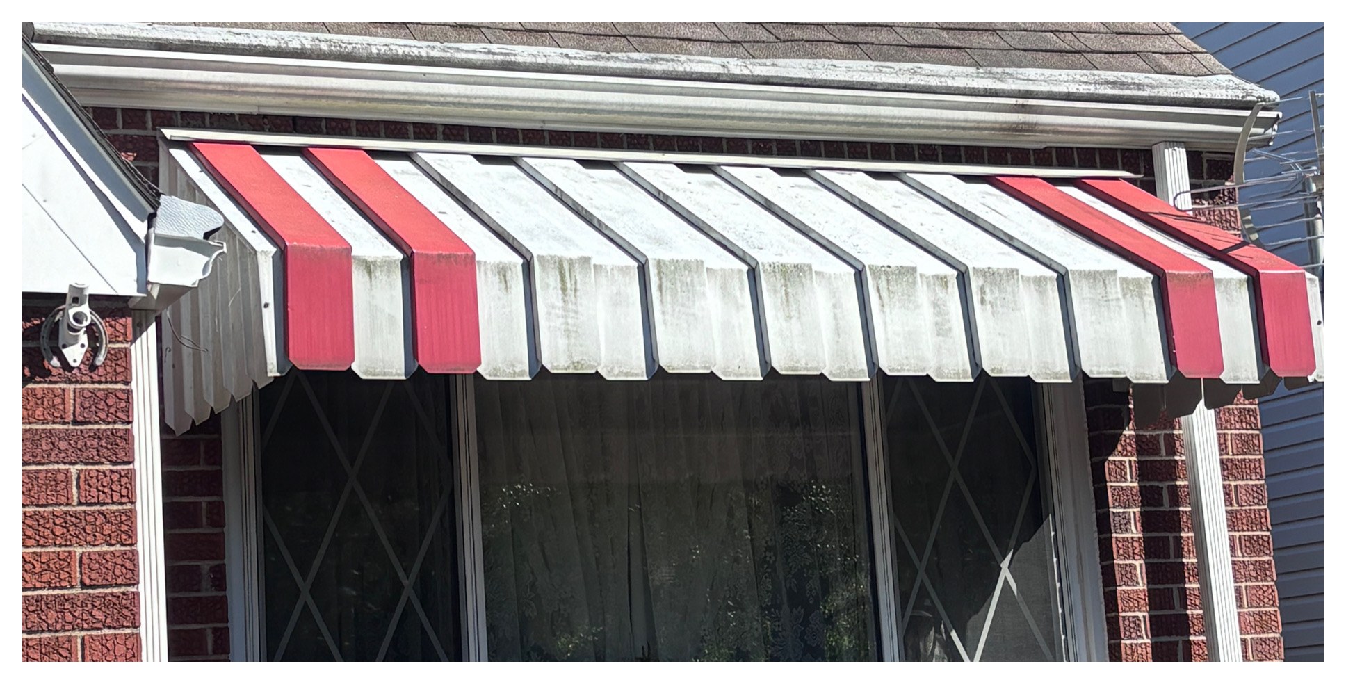 Striped window awning cleaning before